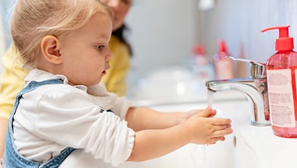 Photo of little kid washing hands