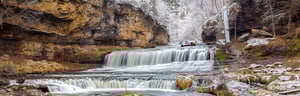 Gentle waterfall between two bluffs