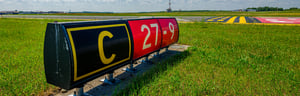 Runway designator sign in grass field