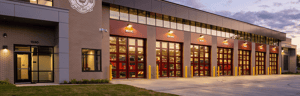 Maplewood North Fire Station with multiple apparatus bay doors at dusk.