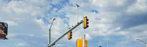 An image of a traffic safety camera on a traffic light pole.