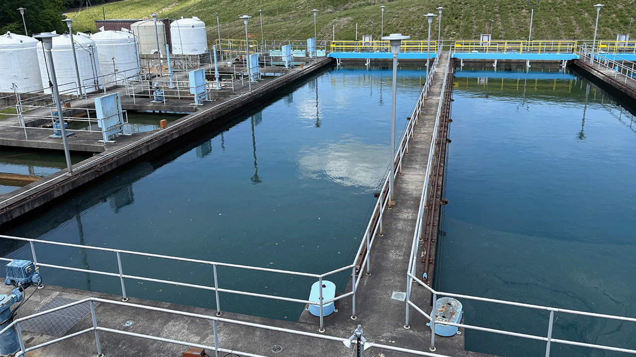Robert A. Harris Water Treatment facility with large tanks and rectangular pools separated by walkways.