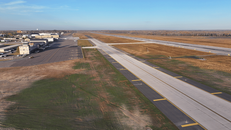 Taxiway reconstruction and paving progress at a major airfield intersection.