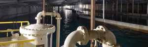 Banner image showing the interior of the City of Richmond’s waterworks facility with pipes, machinery, and a large water pool under metal beams.