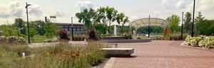 Riverfront pavilion area with trees and sunshade
