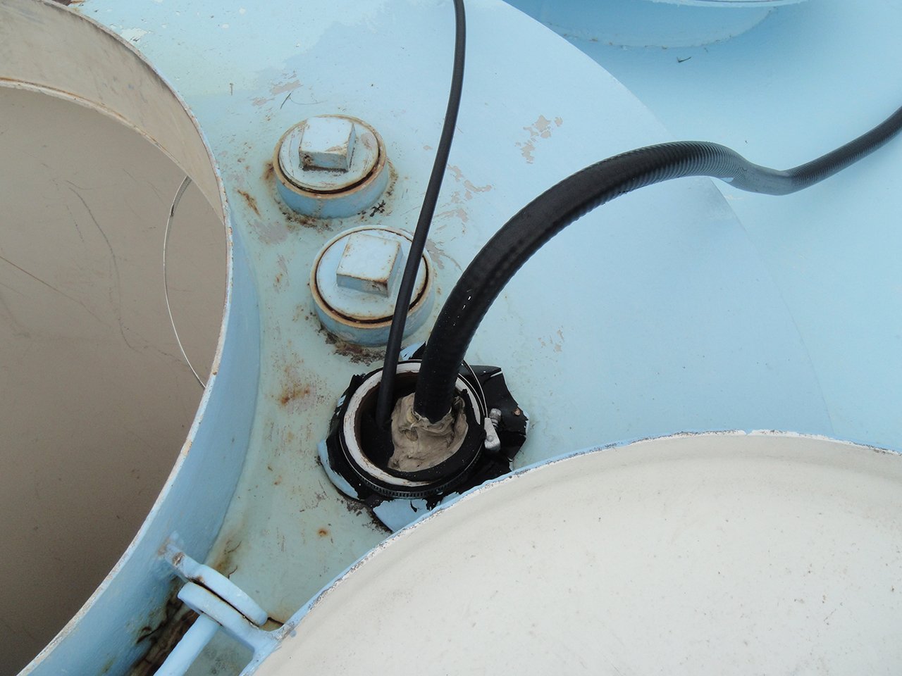 telecom cables enter the top of the tank near the access hatch